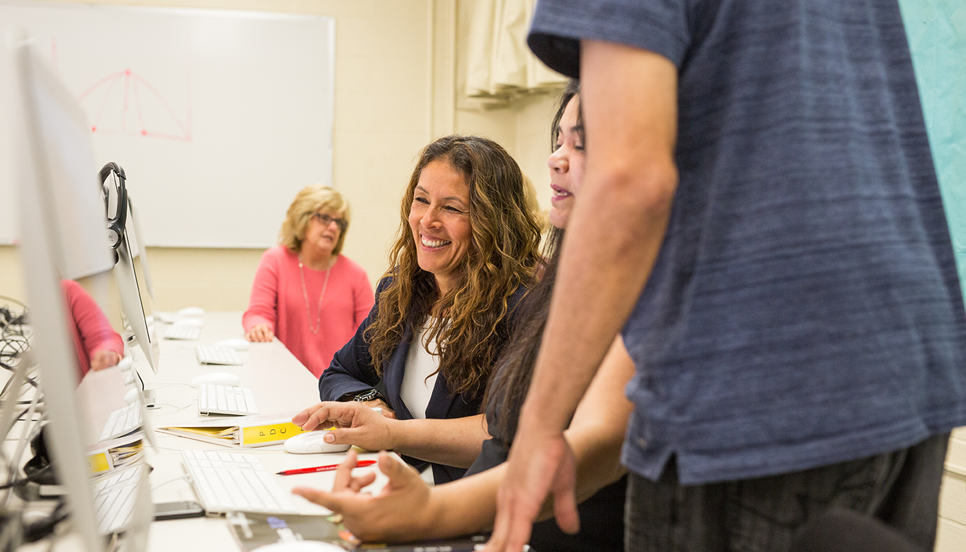 SBCC students learning computer applications on a computer.