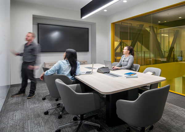 A modern conference room with the people inside having a meeting.
