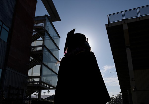 A shadow of a student in regalia