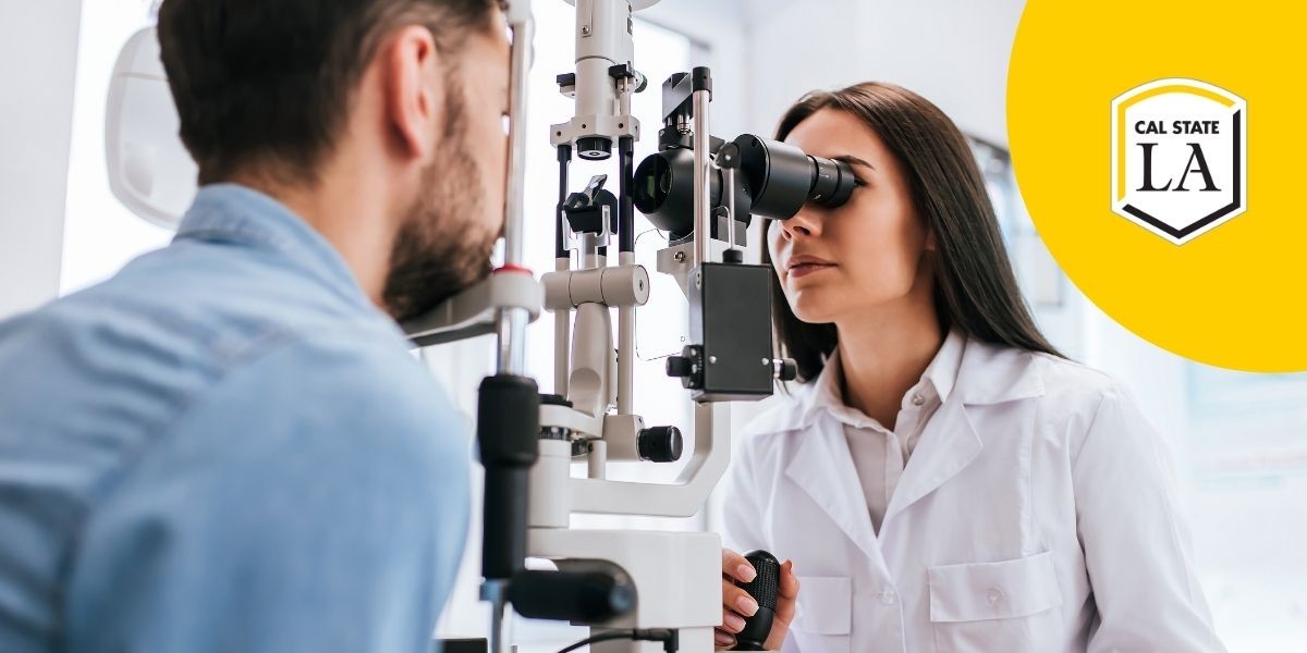 Female eye doctor in white coat examining male patient's eye through a machine