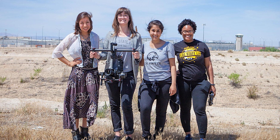 P﻿hoto: Heather Fipps Description: four Cal State LA students with cameras filming in the desert 