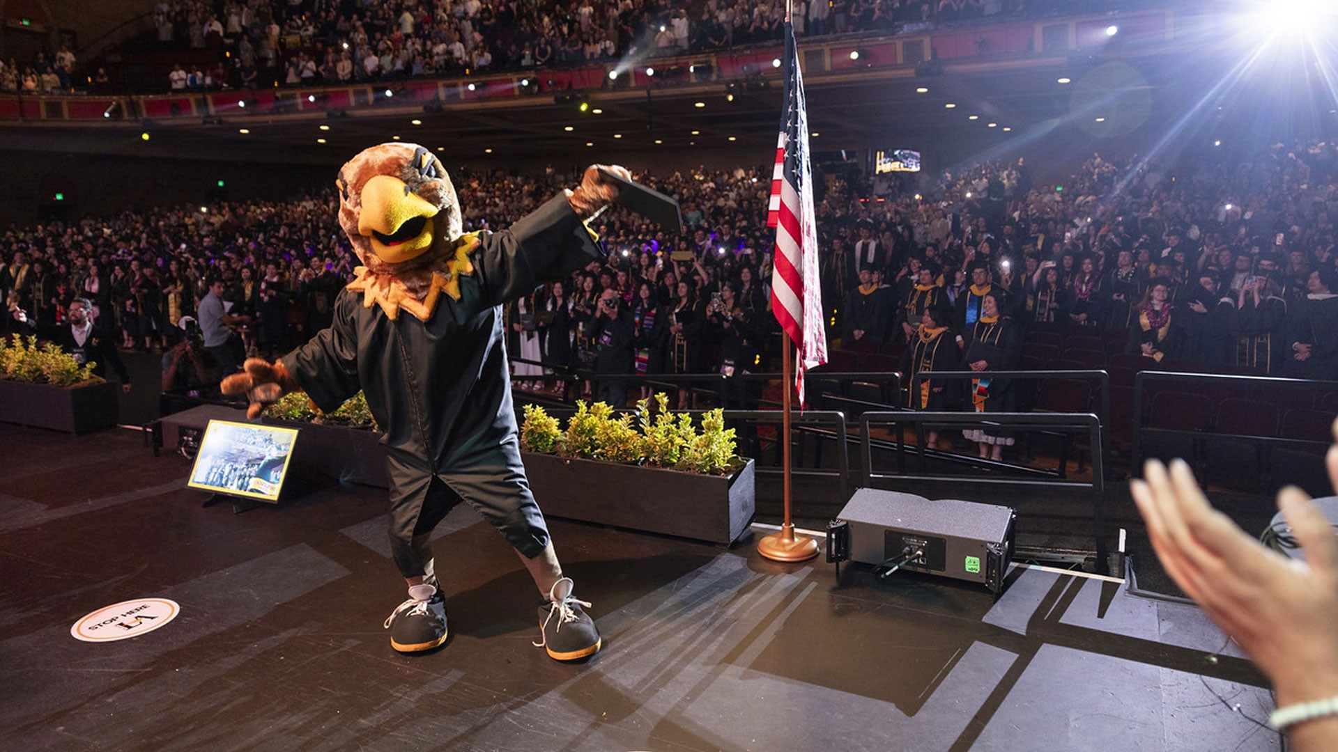 Eddie the Eagle mascot celebrating during Commencement 2025.